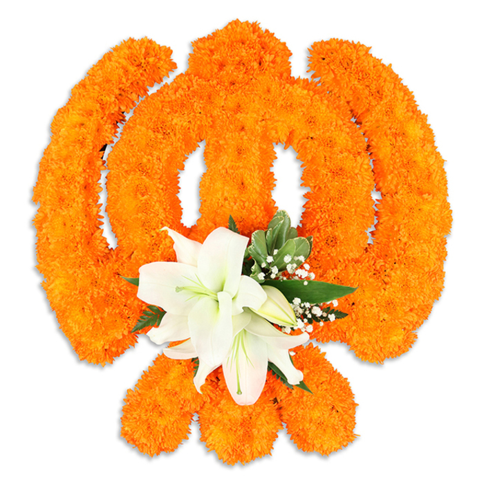 An elegant, reverent floral Ik Onkar rendered entirely from bright orange marigold blossoms takes centre stage against a clean white background. The traditional Ik Onkar character - the flowing numeral '1', its crescent-like extensions and the final dot - is carefully modelled from thousands of tiny, tightly packed marigolds whose plush faces form continuous, warm orange strokes that read with strong visual clarity and a soft tactile richness. At the lower centre of the symbol a cluster of pristine white lilies offers a calm focal point: two or more fully open lilies with gently arched petals display pale green and yellow stamens while several unopened buds promise continuity and renewal. Surrounding the lilies, pointed glossy green leaves and delicate sprays of white filler flowers such as gypsophila provide cooling contrast, subtle texture and a sense of layered depth that makes the marigold field feel sculpted rather than flat. A faint shadow beneath the arrangement lends a three-dimensional presence, as if the Ik Onkar rests slightly above the surface - a ceremonial badge or devotional plaque prepared for a shrine. The warmth of orange marigolds paired with the lilies' quiet fragrance evokes devotion, unity and celebration; it is the kind of piece you might see in a Bounds Green household after a procession from a nearby gurdwara, or placed as a centrepiece during Vaisakhi or Guru Nanak Jayanti. The image communicates reverence, craftsmanship and floral tradition, shaped by local rhythm and respectful intention.