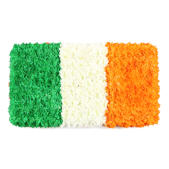 An elegant, dignified reimagining of the Irish flag, this rectangular floral canvas rests against a clean white backdrop. The left stripe glows emerald green, the center stripe lies in bright white, and the right stripe shines with orange-each built from thousands of tiny petals and arranged to produce a uniform, sculpted texture. The petals are densely packed, creating a three-dimensional surface that invites a sense of touch and discovery. The arrangement preserves precise flag proportions, ensuring a faithful representation that remains simultaneously ceremonial and artistic. The colour story remains faithful: green for Catholic heritage and Irish nationalism, white for lasting peace, orange for the Protestant tradition. The mood is respectful and composed, making the piece suitable for heritage features, St Patrick's Day celebrations, or remembrance events. Crafted by a local florist from Bounds Green, it speaks to the care of living materials used to convey meaning, and is available for delivery across Bounds Green and nearby areas, with options for same-day service to support editorial deadlines or event planning.