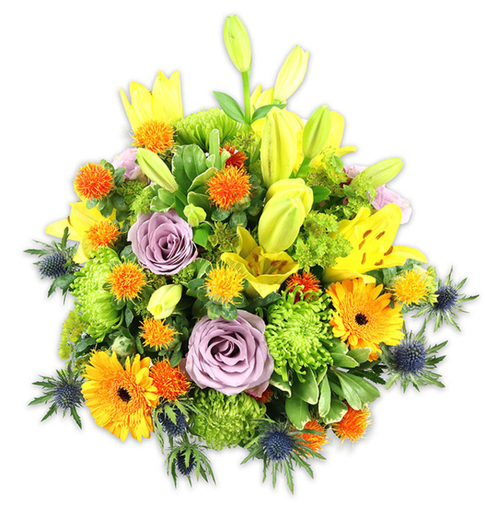Presented on a clean white background, this densely packed floral composition reads as an energetic yet refined statement. Several luminous yellow Asiatic lilies dominate the picture plane-some fully unfurled with their characteristic speckled petals and exposed stamens, others tightly furled in elongated chartreuse-yellow buds that introduce height and expectancy. Two soft lavender-purple roses sit near the heart of the arrangement, their delicate spirals offering a cool, romantic focal point amid the warmer hues. The joyful, broad faces of orange Gerbera daisies fan outward from darker centres, creating bright, sun-like accents, while abundant lime-green 'button' chrysanthemums provide textured, ruffled massing that feels almost verdant and mossy. Interspersed throughout are small, rounded, spiky orange and golden-yellow blossoms which enliven the mid-levels with playful pops of colour. Cool-toned sea thistles (Eryngium) in blue-grey emerge along the lower and lateral edges, their starry bracts and rigid stems supplying an architectural counterpoint to the softer blooms. A mix of glossy and matte green foliage-broad lily leaves, slender sprays and compact filler-grounds the bouquet and lends depth to the overall silhouette.

Bathed in soft, even light the bouquet suggests an afternoon of celebration or a quiet, thoughtful remembrance: the lilies' sweet fragrance layered with green, leafy notes, the tactile contrast of silky petals against spiky thistles, and the visual rhythm created by repeating shapes and colours. Thoughtfully composed for life in Bounds Green-near the Tube and within easy reach of Alexandra Park-this arrangement would sit beautifully as a centrepiece on a dining table or arrive as a considered gift for birthdays, anniversaries or to brighten a neighbour's day.