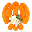A deeply respectful floral rendering of the Khanda, the central emblem of Sikh faith, set against a pristine white backdrop. The whole symbol is sculpted from hundreds of small, densely clustered bright orange marigold blossoms whose rounded petals create a velvety, tactile surface that catches soft studio light and reads as warm, celebratory orange. The composition clearly defines the Khanda's components: the circular chakkar, two crossed kirpans behind it and the upright double-edged khanda in the centre, each line rendered by the careful placement of individual marigolds to create a three-dimensional, almost bas-relief effect. At the heart of the piece, where the swords meet, a cluster of elegant white lilies offers calm contrast - at least two fully open lily blooms with gently unfurling petals and delicate green and yellow stamens, surrounded by tighter white buds. Sprays of tiny white filler flowers, like gypsophila, nestle among glossy green foliage - the pointed salal-like leaves and soft greenery add depth, coolness and a natural frame to the warmth of the marigolds. A faint drop shadow beneath the arrangement suggests it is a freestanding display or ceremonial offering, photographed in soft, even light to emphasise texture and form. The overall effect is reverent and celebratory, evoking Vaisakhi, Gurpurab and community gatherings in local gurdwaras. As a local florist's piece from Bounds Green neighbourhoods around Bowes Park, Wood Green and Palmers Green, it reads as both an artistic tribute and a spiritual emblem crafted for remembrance, festival decoration or sanctuary display.