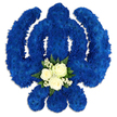 A large, carefully shaped Khanda floral tribute fills the scene, its meaningful Sikh symbolism made clear by the precise outline of the central sword, the round chakkar, and the two curved kirpans, all presented on a clean white background. Every element of the emblem is constructed from a tightly packed layer of royal blue chrysanthemums or similar small cluster flowers, their many petals forming a plush, almost quilted surface. The deep blue colouring is consistent throughout, giving the piece a confident, dignified presence, like a bold banner of faith set against the quiet streets of Bounds Green. At the lower part of the central circular area, a contrasting floral detail draws attention. Here, three immaculate white roses sit together, their petals soft and full, suggesting love, remembrance, and a gentle farewell. They are encircled by dainty sprays of tiny white filler flowers, akin to baby's breath, which bring a cloud-like softness, and by dark green foliage that introduces a touch of natural woodland freshness. Subtle shadows around the base of the arrangement create a sense of depth, as though the Khanda is resting slightly raised on a table or stand in a peaceful room before a service. This tribute feels both strong and serene, designed for Sikh funerals, memorials, or commemorative services where families wish to honour their loved one's beliefs, roots, and values. It reflects the kind of thoughtful, respectful work you might commission locally when arranging farewell flowers for a Bounds Green family.